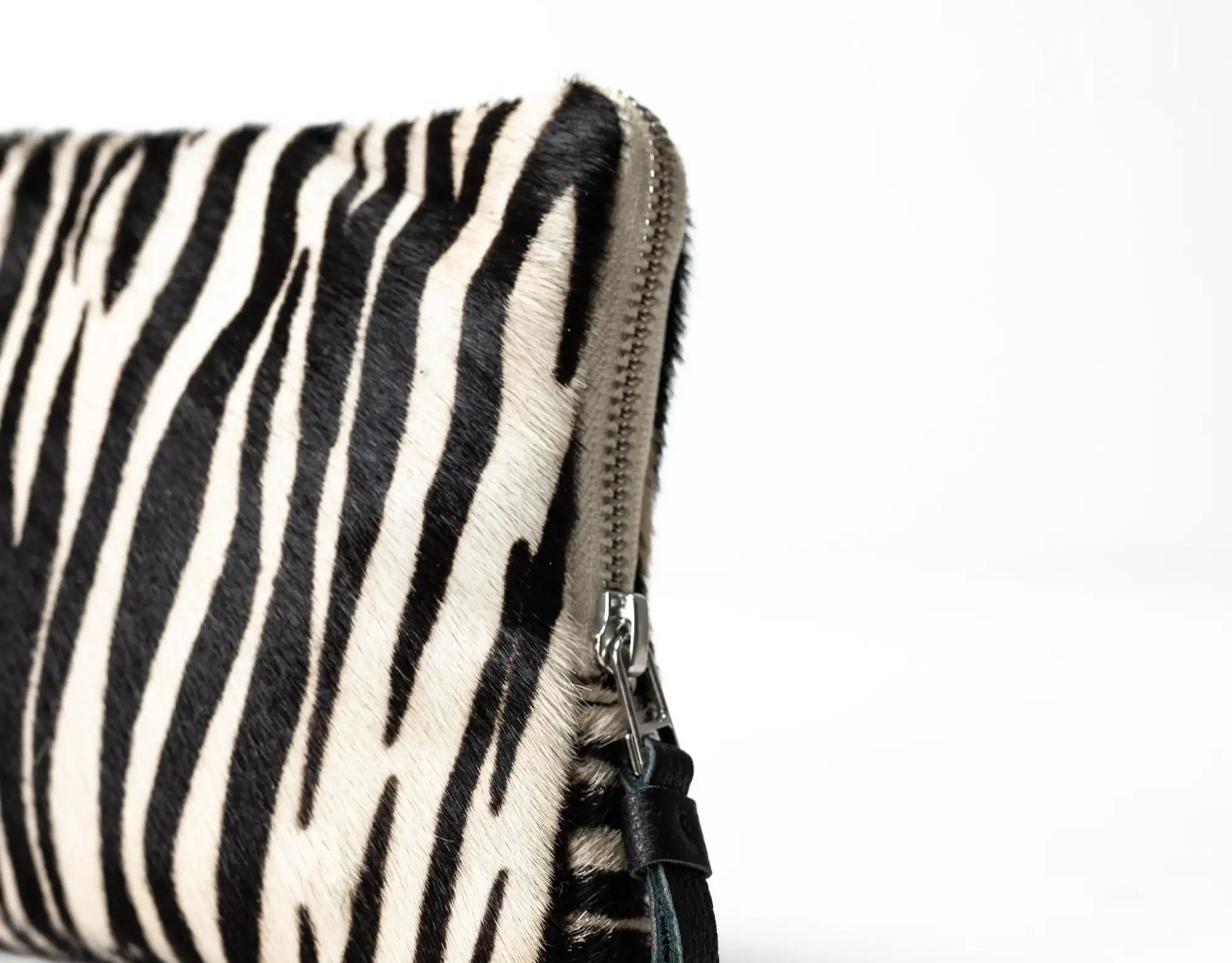 Zebra-patterned pouch with a zipper on a white background