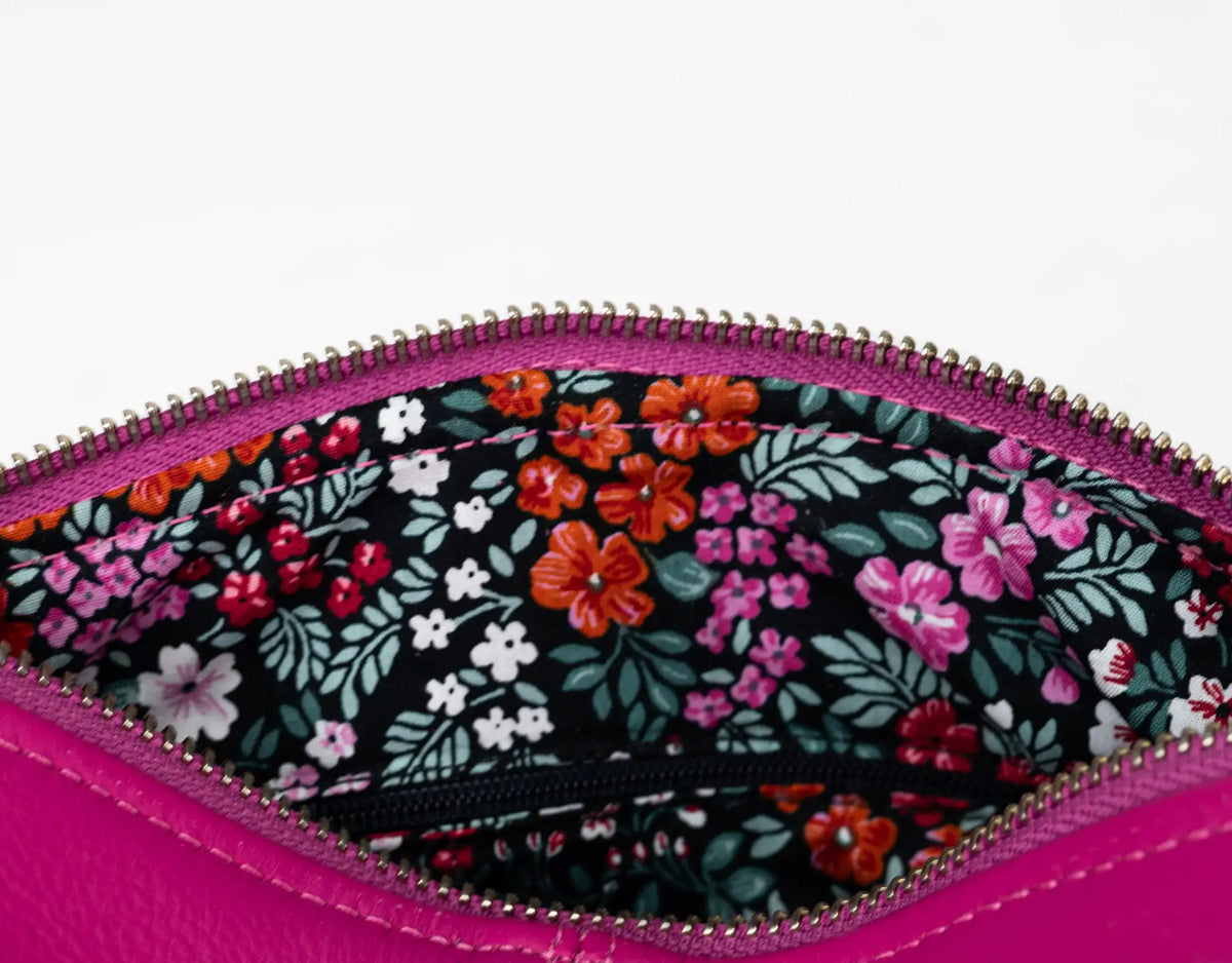 Floral-patterned pouch with pink zipper on a white background#color_deep-pink