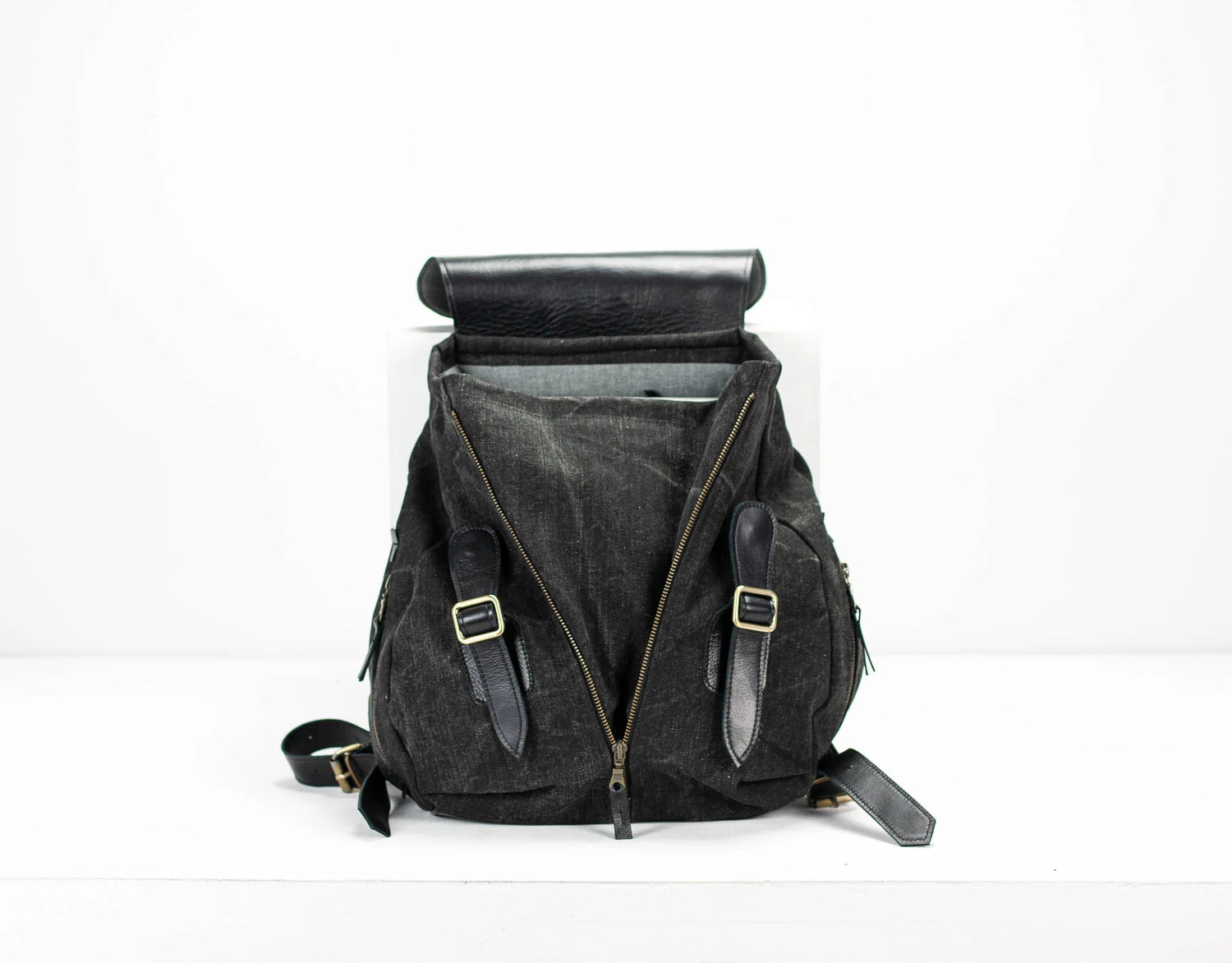 Black backpack with straps on a white background