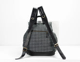 Backpack with houndstooth pattern and black straps on a white background