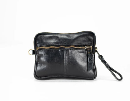 Black leather clutch with gold zipper on a white background