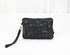 Black woven handbag on a white background