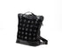 Black quilted backpack on a white background
