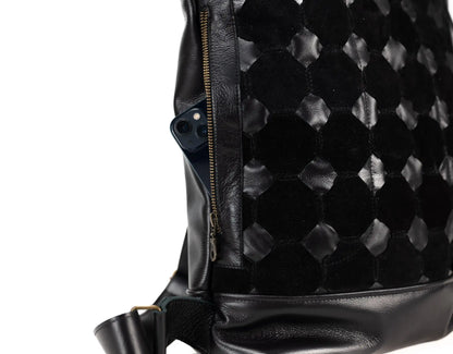 Black textured backpack with a visible brand logo on a white background