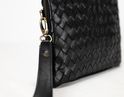 Black woven leather clutch bag with gold zipper on a white background