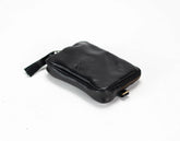 Black leather pouch with gold zipper on a white background