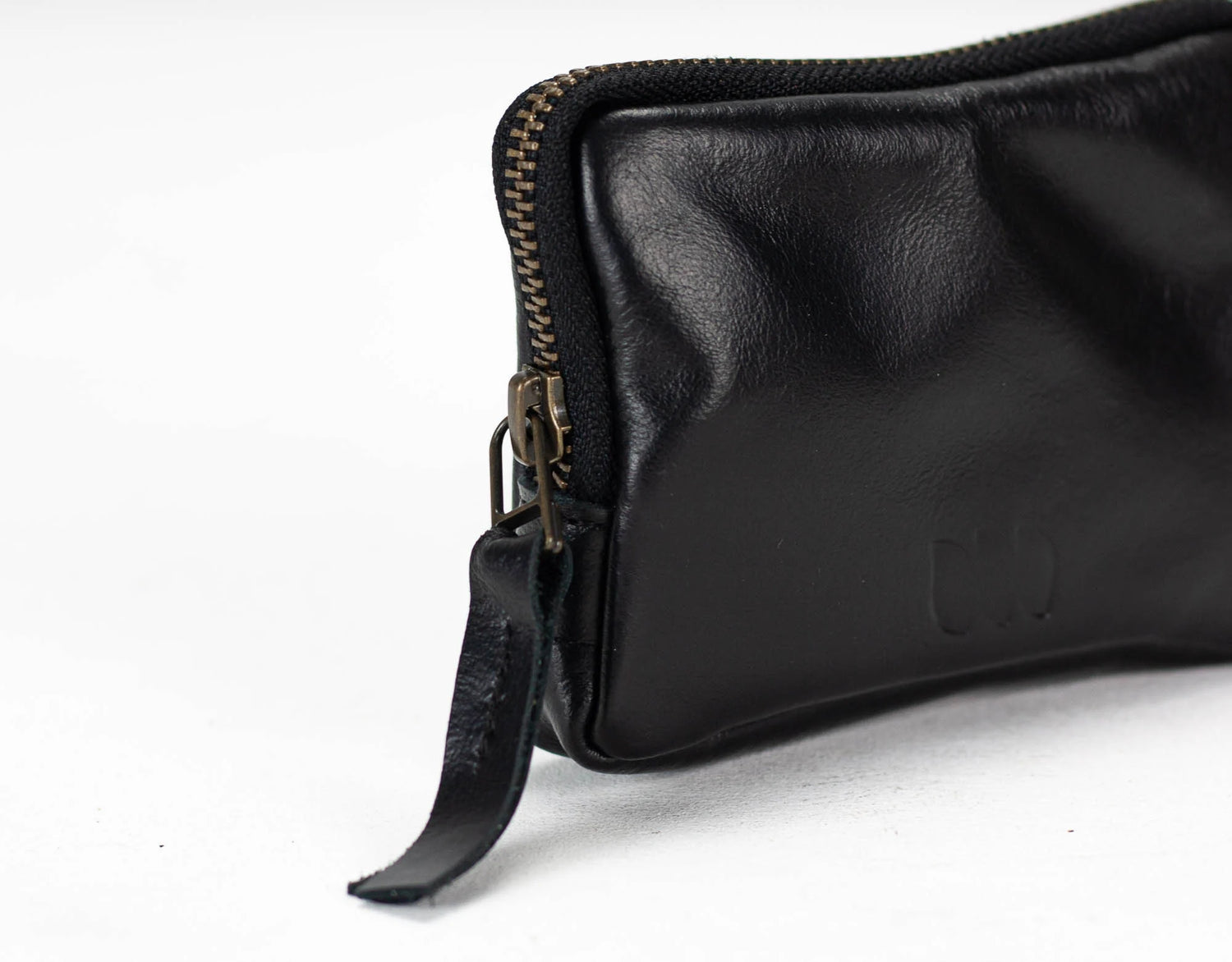 Black leather pouch with zipper on a white background