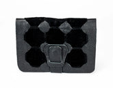 Black hexagonal patterned pouch with a flap on a white background