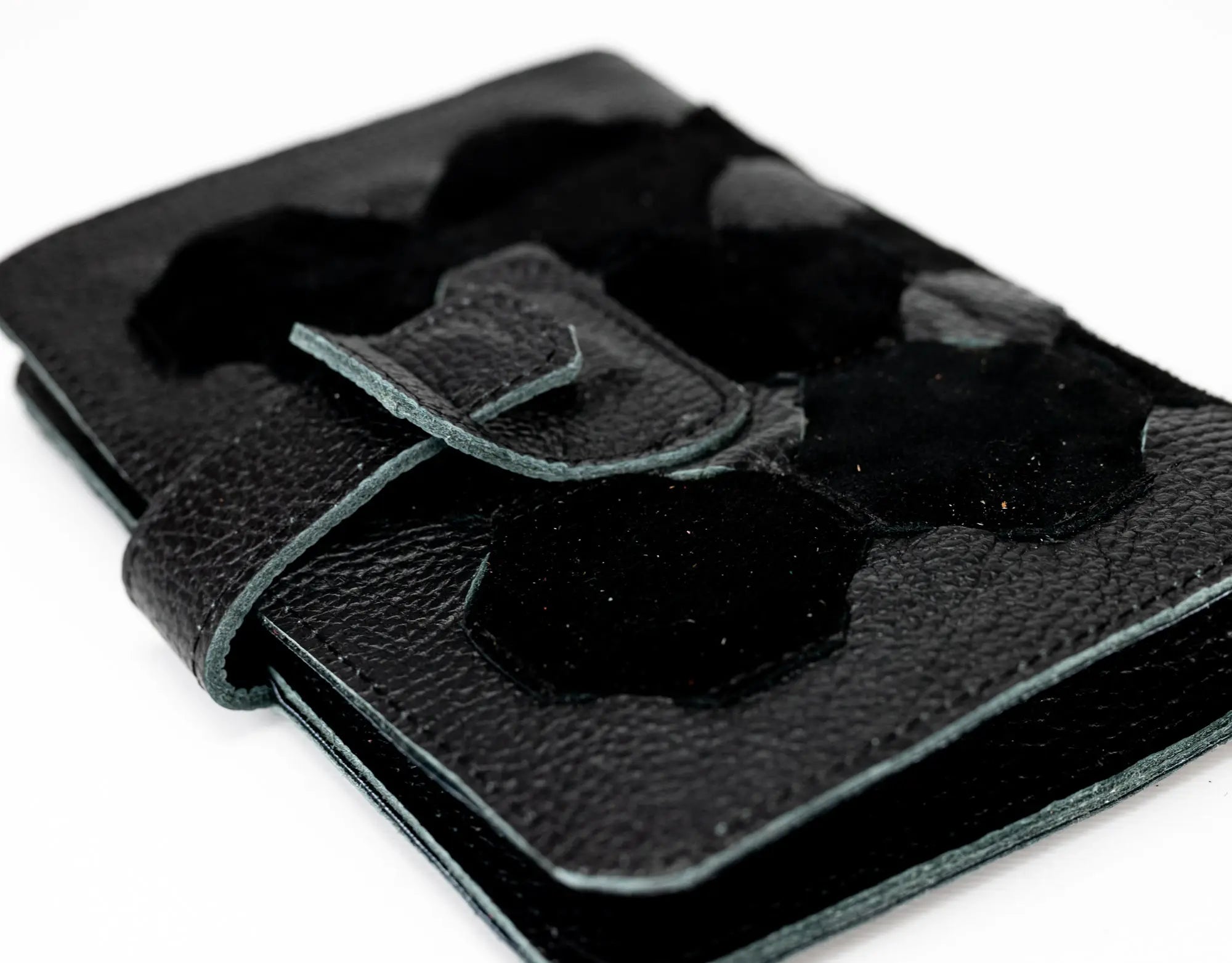 Black leather wallet with a buckle detail on a white background