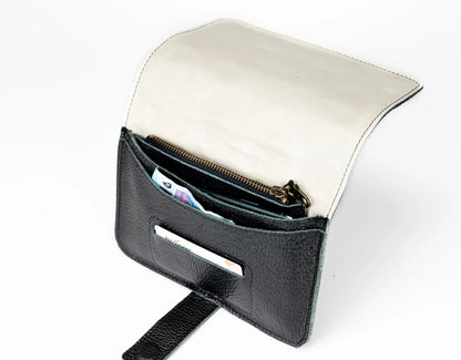 Black leather clutch with gold zipper on a white background