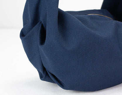 Close-up of a navy blue bag on a white background