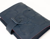 Blue textured wallet with a buckle on a white background