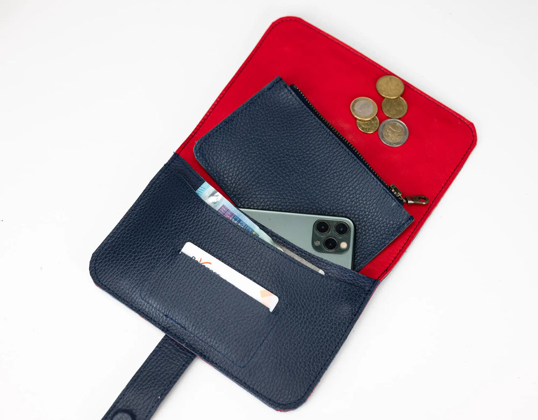 Black wallet with phone and coins on a red pouch