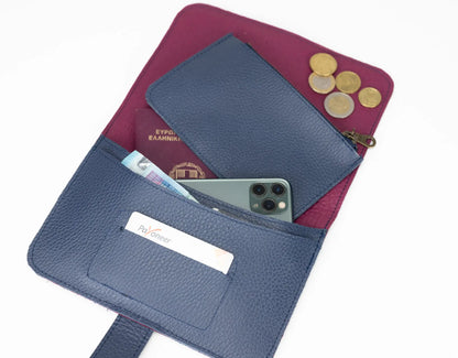Blue wallet with phone, cards, and coins on a white background