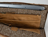 Brown patterned bag with a compartment for a laptop on a white background