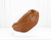 Brown leather waist bag on a white background
