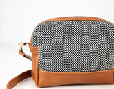 Handbag with black and white patterned top and brown leather sides