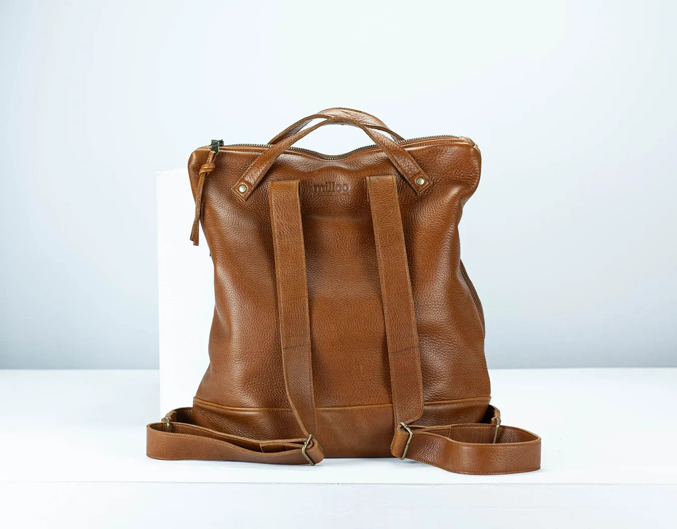 Brown leather backpack on a white background