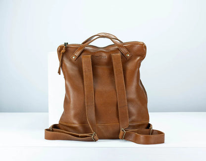 Brown leather backpack on a white background