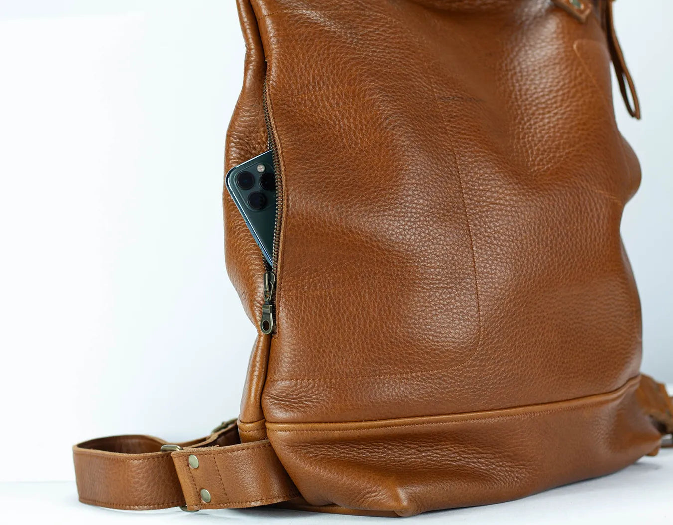 Brown leather backpack on a white background