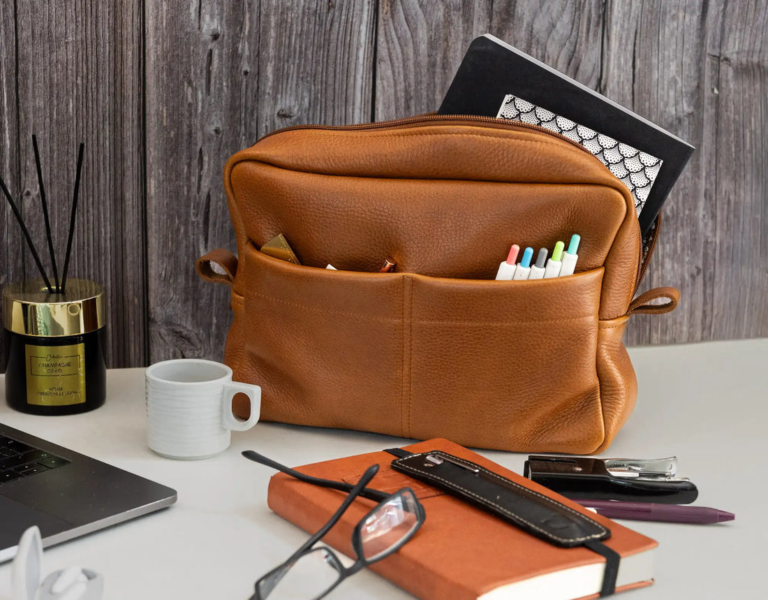Brown leather pouch on a desk with office supplies