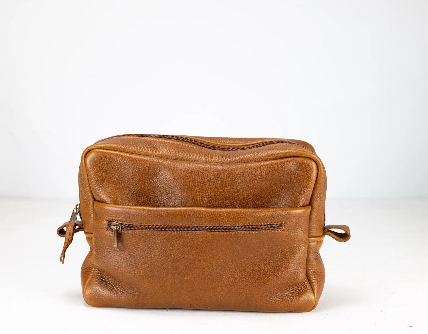 Brown leather bag with a zipper on a white background