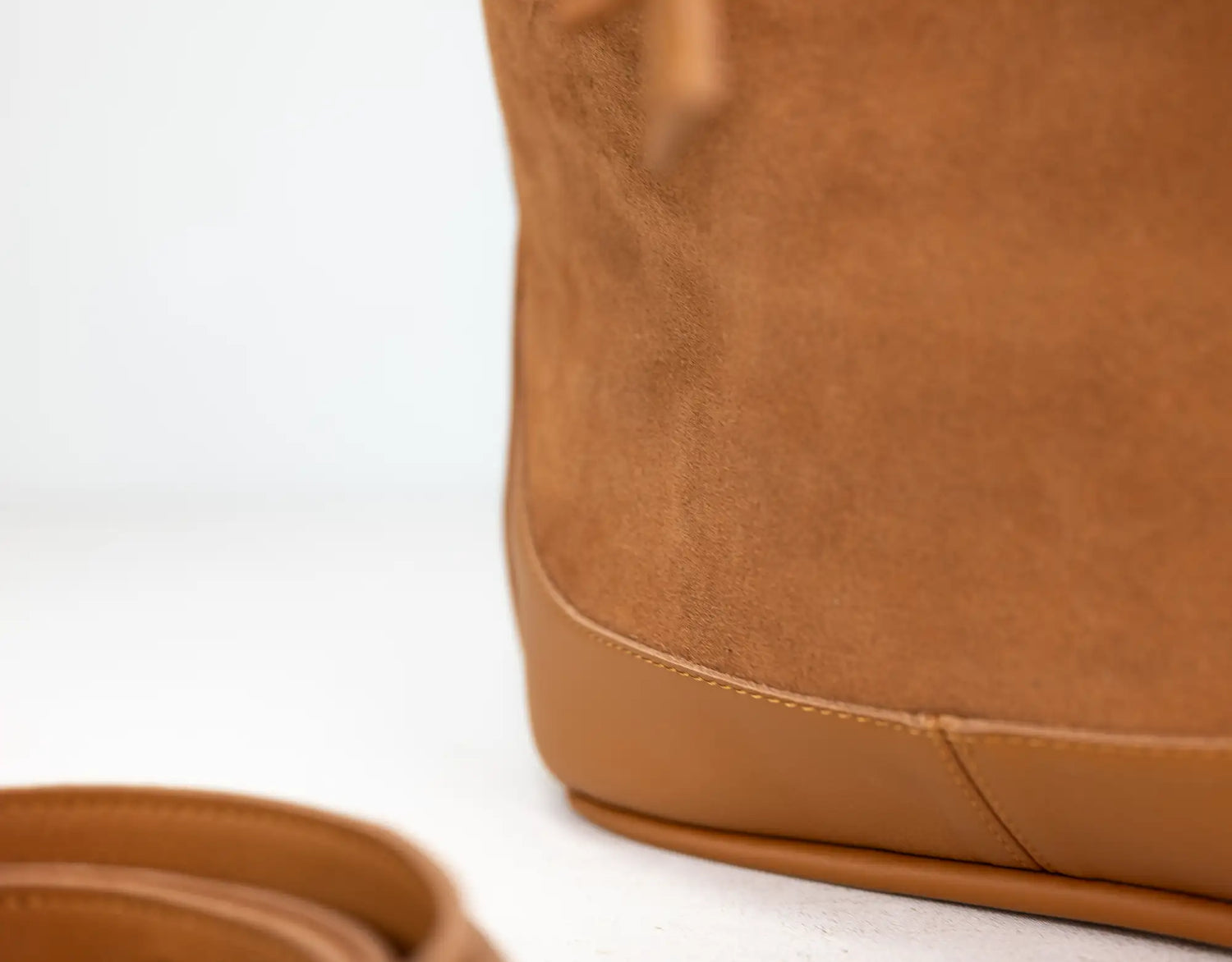 Close-up of a brown leather bag on a white background