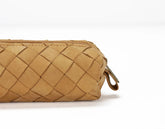 Tan woven clutch bag on a white background