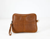 Brown leather pouch with a strap on a white background