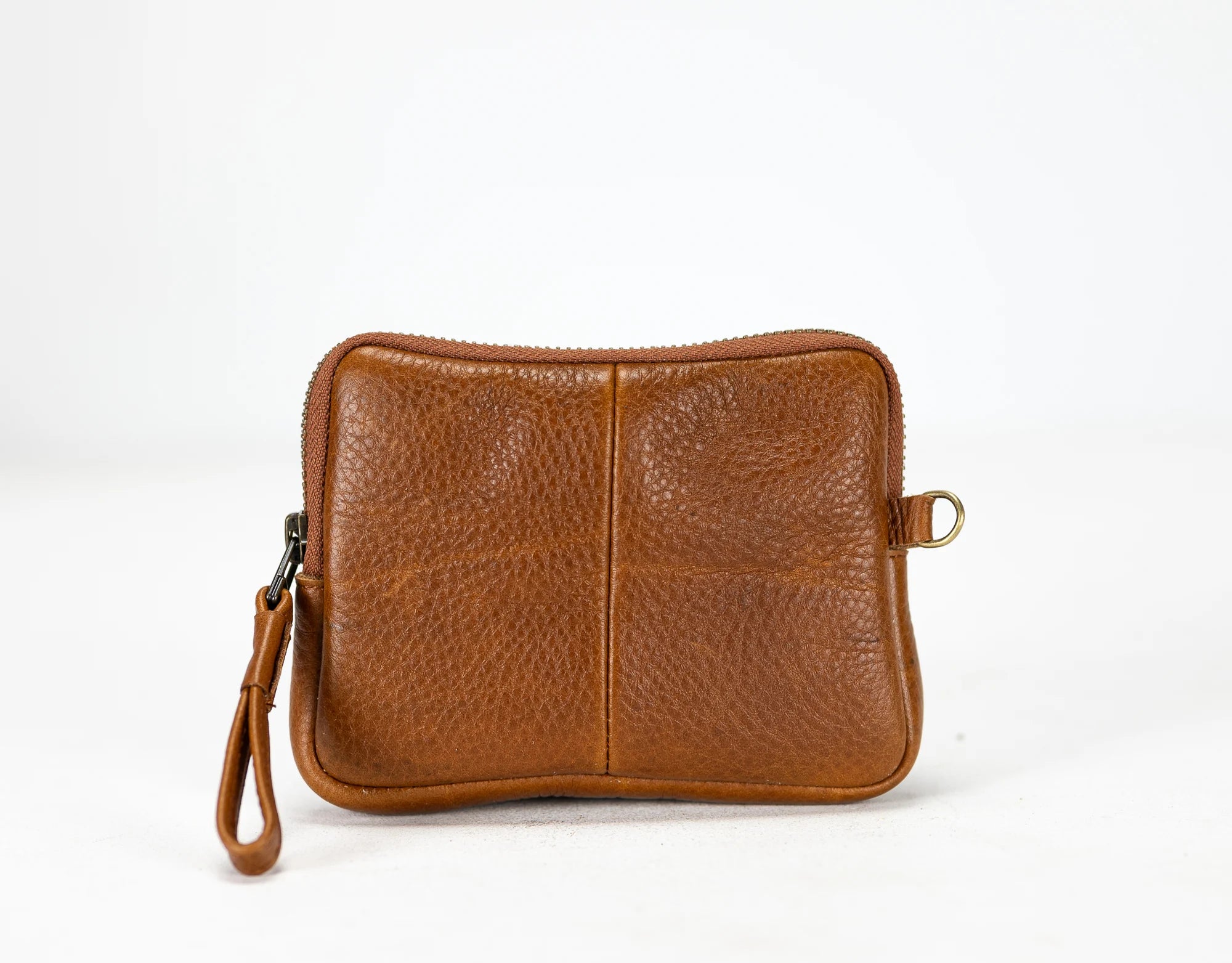 Brown leather pouch with a strap on a white background