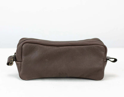 Brown leather toiletry bag on a white background
