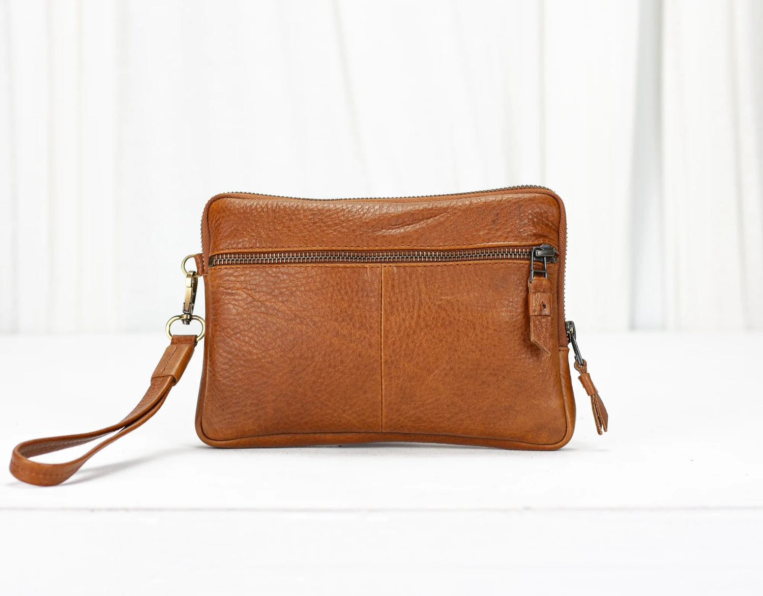 Brown leather crossbody bag on a white background