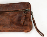 Brown leather wallet with credit cards inside on a white background