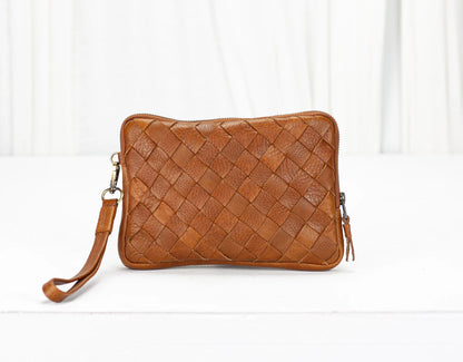 Brown woven leather clutch bag on a white background