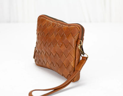 Brown woven leather crossbody bag on a white background