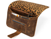 Brown leather bag with leopard print top section on a white background