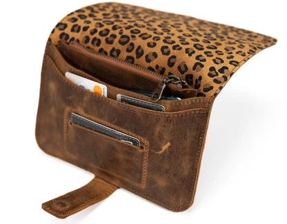 Brown leather bag with leopard print top section on a white background