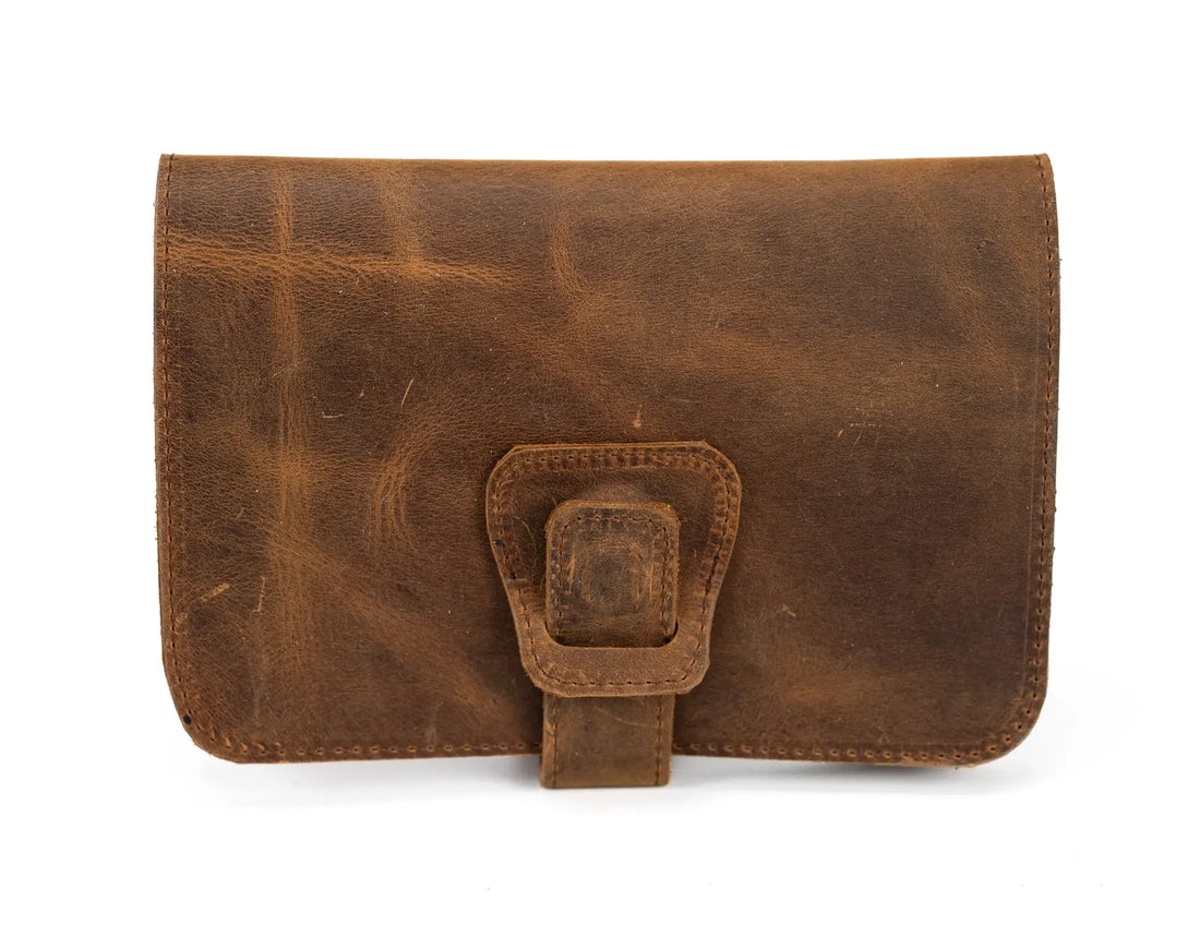Brown leather pouch with a buckle on a white background