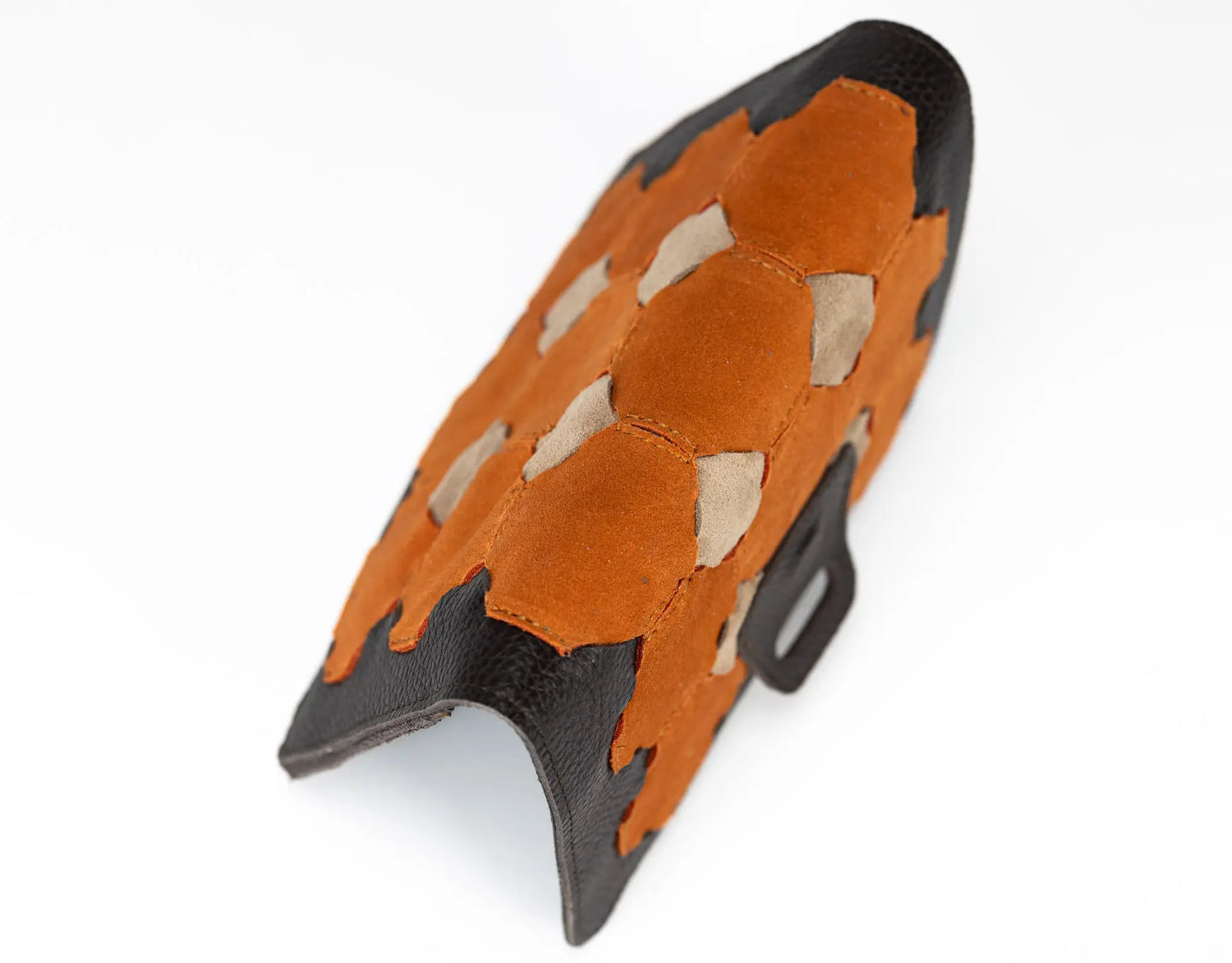 Orange and black textured object on a white background