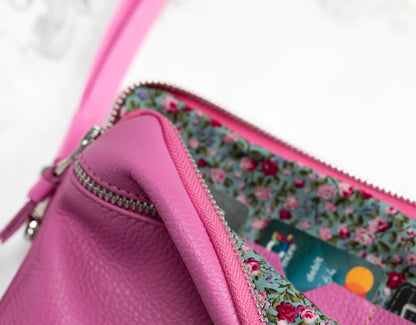 Pink wallet with floral lining and visible credit card