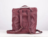 Maroon leather backpack on a white background