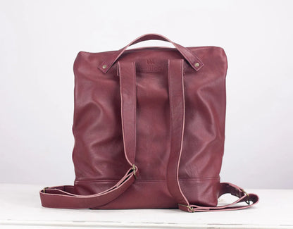 Maroon leather backpack on a white background