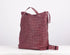 Maroon woven leather bag on a white background