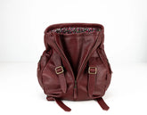 Brown leather backpack with floral lining on a white background