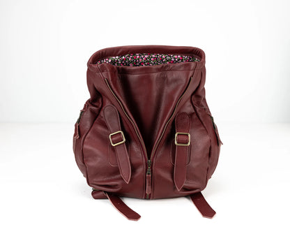 Brown leather backpack with floral lining on a white background