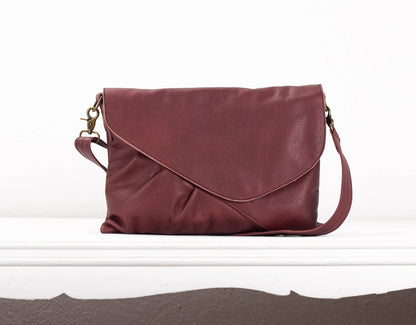 Maroon leather handbag on a white background