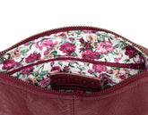 Floral-patterned interior of a pink handbag with visible brand name.