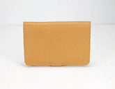 Tan leather wallet on a white background