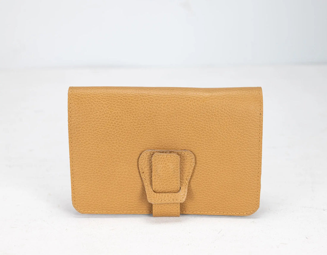 Yellow wallet with a buckle on a white background