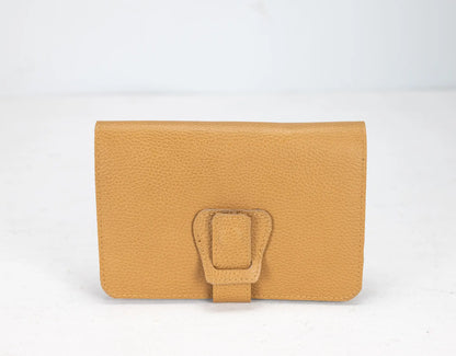 Yellow wallet with a buckle on a white background